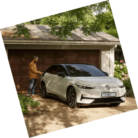 Man plugs an EV charger into the port of white electric VW
