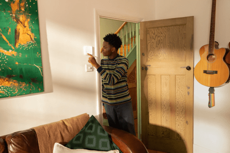Man checks a Beyond Smart thermostat